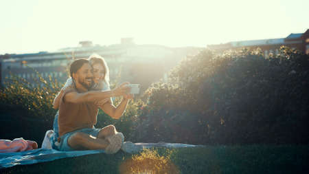 Young couple doing selfie in the parkの写真素材