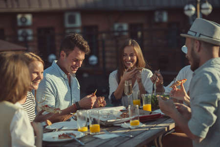 Young attractive people at a party on the roofの写真素材