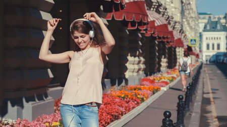 Dancing young woman in the streetの写真素材