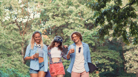 Young smiling skateboarders outdoors