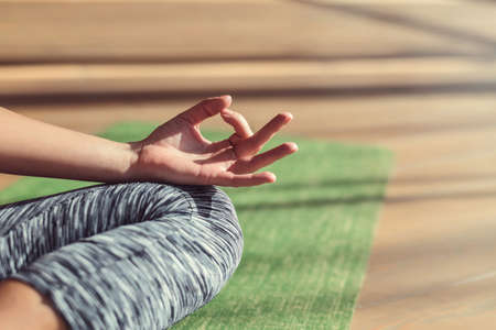 Young girl practicing yoga close-up