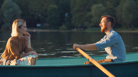 Young attractive couple in a boatの写真素材