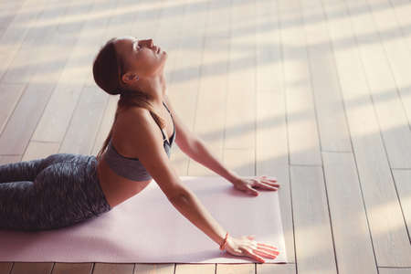 Attractive woman doing yoga indoorsの写真素材