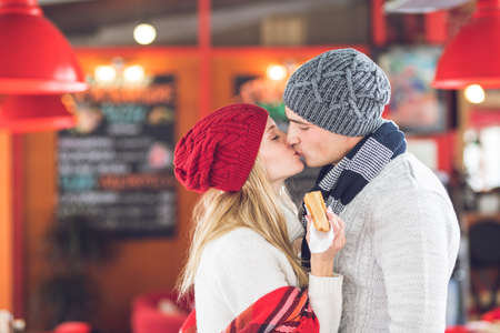 Kissing young couple in a cafe