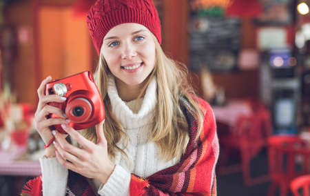Young girl with camera in a cafe