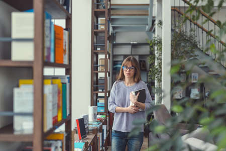 Young attractive girl in a bookstore