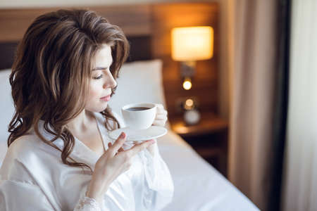 Beautiful young bride at homeの写真素材