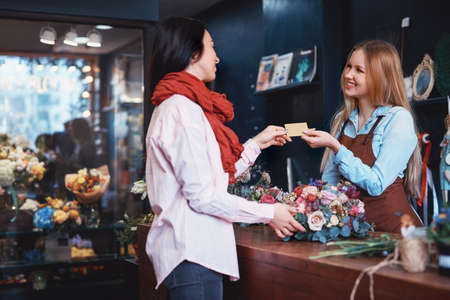 Young girl buying a bouquet of flowersの写真素材