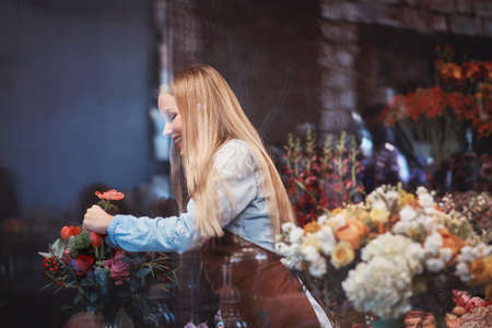 Young florist with flowersの写真素材