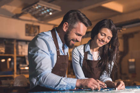 Smiling young people in workshopの写真素材