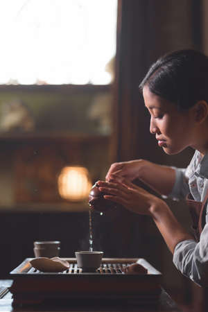 Young girl pouring teaの写真素材