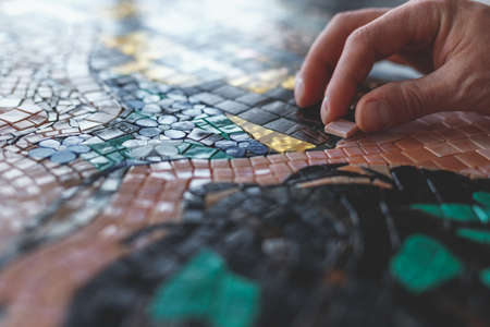 Mens hands with mosaic