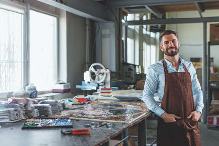 Smiling man in workshopの写真素材