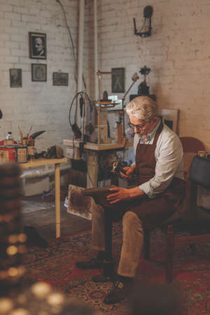 Elder cobbler in the workshop