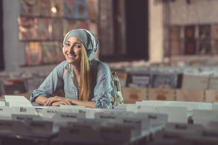 Smiling girl with headphones in a storeの写真素材