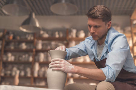 Young man at a potters wheelの写真素材
