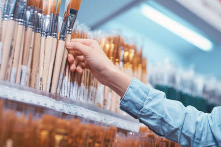 Female hand with art brushesの写真素材