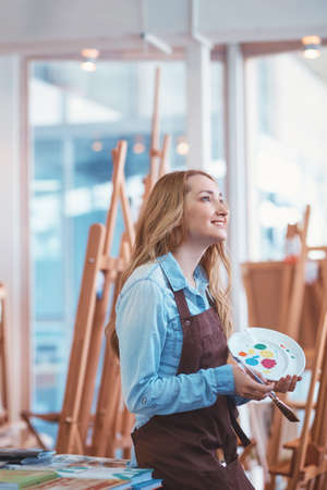 Smiling attractive girl at work in studioの写真素材