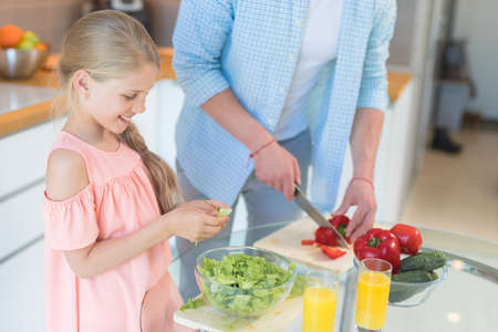Dad and daughter cookingの写真素材