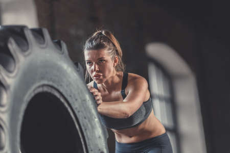 Sports young woman with a wheel close-upの写真素材