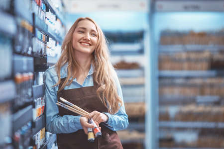 Smiling young girl with a brushの写真素材