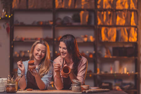 Smiling young girls in potteryの写真素材