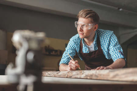 Young carpenter in the workshopの写真素材