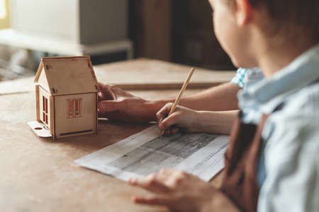 Little child with a wooden houseの写真素材