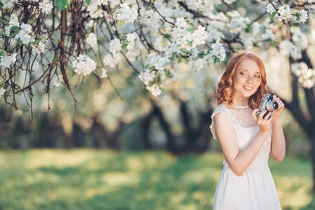 Young beautiful woman in a blooming gardenの写真素材