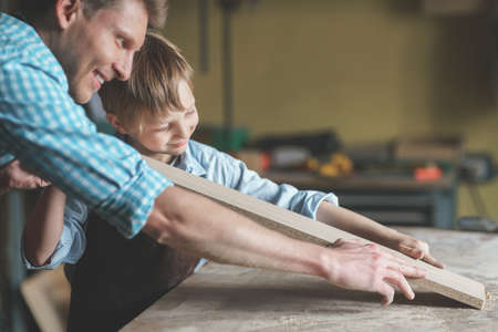 Smiling family in carpentryの写真素材