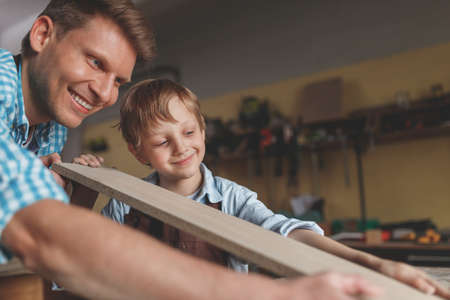 Happy family in the workshopの写真素材