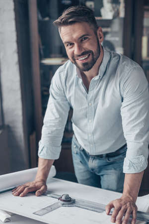 Smiling mature man with drawing