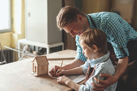 Smiling people with a wooden houseの写真素材