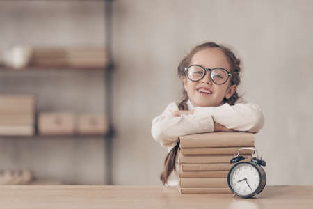 Smiling schoolgirl with books