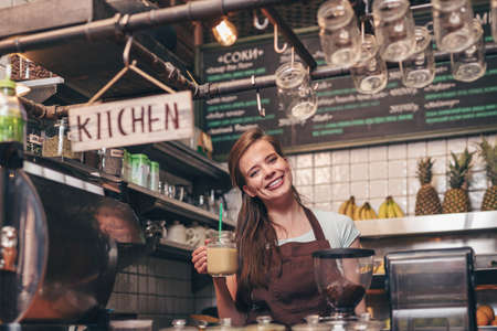 Smiling woman with smoothies