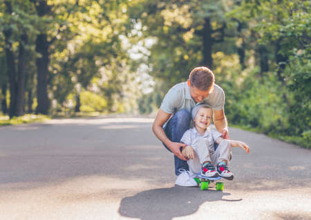 Father and son skating in summerの写真素材