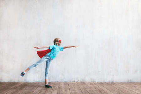 Flying girl hero with a cloakの写真素材