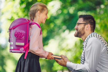 Little schoolgirl with fatherの写真素材