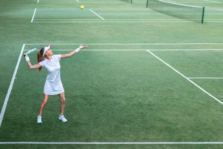 Active young woman on the tennis courtの写真素材