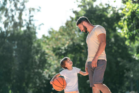 Young family with a ball on the basketball courtの写真素材