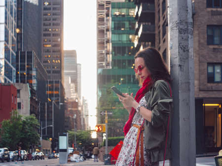 Attractive girl with a phone on the street in New York