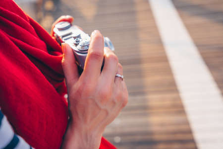 Female hands with a retro camera close-upの写真素材