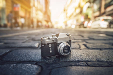 Retro photo camera on the road in Europeの写真素材