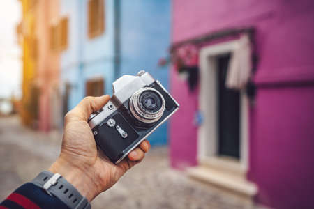 Photographer holding a retro camera in Burano closeupの写真素材