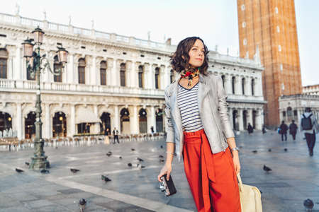 Attractive girl with a retro camera on the Piazza San Marcoの写真素材