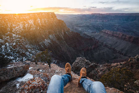 Men's legs on the background of the Grand Canyon National Park