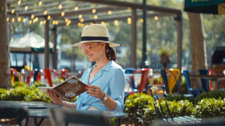 Attractive woman with a travelbook in park, NYCの写真素材