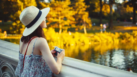 Beautiful girl with a retro camera in Central Park, New Yorkの写真素材