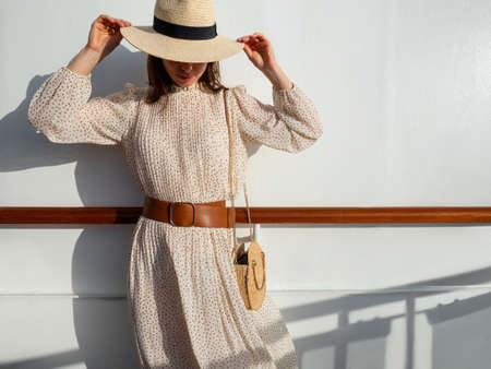 Attractive girl by the wall in the sunの写真素材