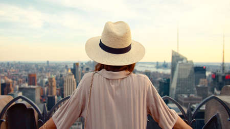 Young tourist in a hat on the roof in New York City